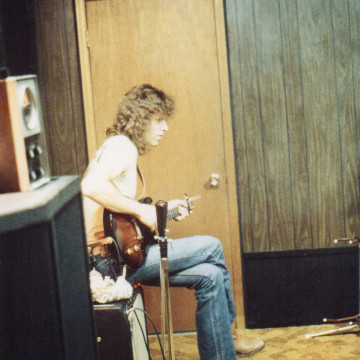 John-Sitting-On-Amp,-Playing