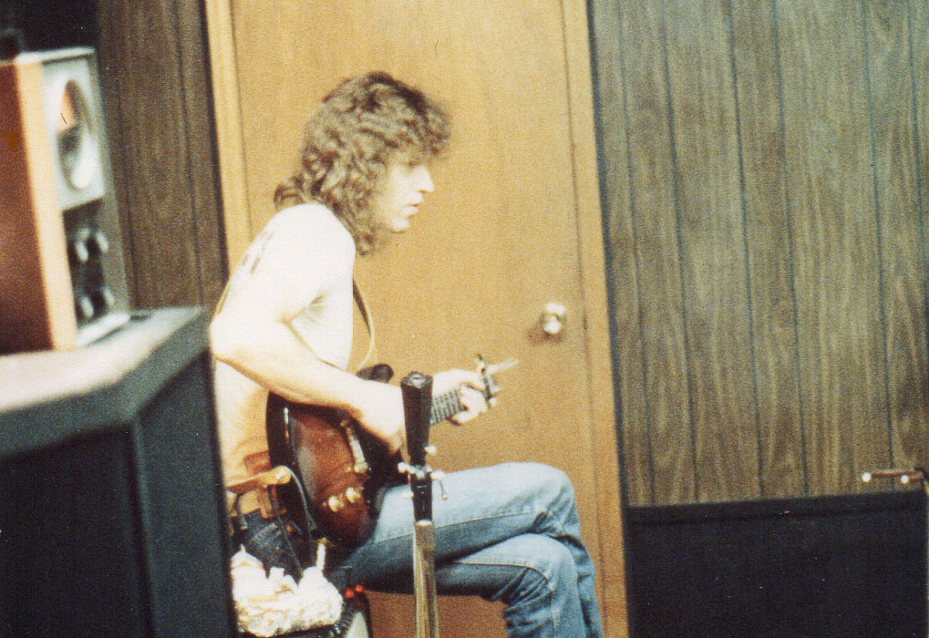 John-Sitting-On-Amp,-Playing